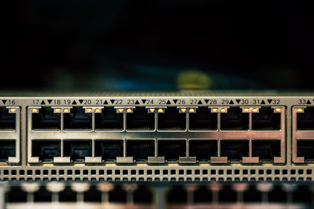 pexels-photo-2881227 Detailed view of a network switch featuring multiple ethernet ports and LED indicators.